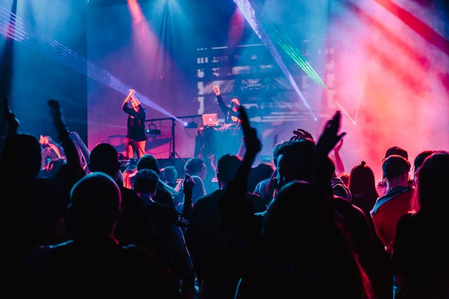 DJs performing on stage for a crowd